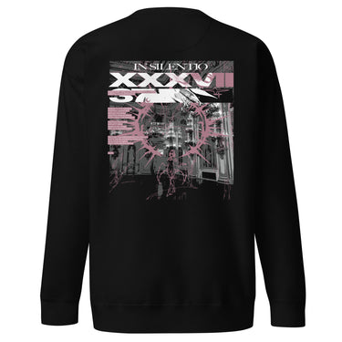 Back view of a sweatshirt in black. A large rectangular back graphic layers an ornate hall interior in high-contrast greyscale beneath oversized roman numerals 'XXXVII' and a serif 'IN SILENTIO' wordmark. Dusty pink text bars carry a short poem down the left edge, cut through by thorned starburst linework in the same pink.