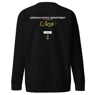 Back view of a sweatshirt in Black. A stacked graphic fills the upper back: "AIRSPACE PATROL DEPARTMENT" in heavy white capitals, "GLORIA NOS DUCIT" in smaller gold capitals beneath it, then "L'Azur" in a large gold script with a long trailing flourish. Below sit a small white box lettered "FIRST SPEAR" in black, a weathered gold seal stamp carrying two characters, and "gen 5" in gold.