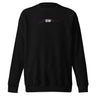 Front view of a Sweatshirt in Black. A small chest graphic reading "silvie" in a bold, hand-lettered signature style, framed by loose script strokes and star accents.