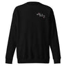 Front view of a sweatshirt in black. A small left-chest graphic reads 'SOLA EGO' in a high-contrast serif, split across two lines, with two four-pointed star accents in dusty pink flanking the type.