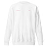 Front view of an sweatshirt in white. Design features small text printed across the upper chest: the word ‘genesis’ on the left side, preceded by a circular symbol, and the word ‘ego’ on the right side preceded by a music note.