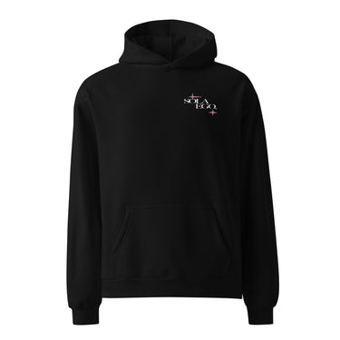 Front view of an oversized hoodie in black. A small left-chest graphic reads 'SOLA EGO' in a high-contrast serif, split across two lines, with two four-pointed star accents in dusty pink flanking the type.