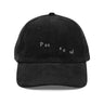 Front view of a corduroy cap in black. The words "pas seul" are embroidered across the front panel in white, the letters set in a fine serif and scattered so they step down and to the right. The cap is an unstructured low-profile six-panel in ridged cotton corduroy, with embroidered eyelets and a metal buckle strap.