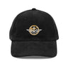 Front view of a corduroy cap in Black. A circular emblem is embroidered on the front panel: a gold ring lettered "MIRACULUM IN CAELO NUMQUAM CADET" in white stitching, with a white winged spearhead standing through its centre and swept wings running out to either side. Unstructured six-panel corduroy crown, curved brim, metal buckle.