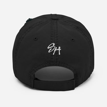 Back view of a solid-colored, distressed hat. The letters "SH" are embroidered in a high-contrast script font above the opening.