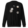 Front view of a solid-colored sweatshirt. The chest features a small signature and four different circular emblems, each containing a unique high-contrast, abstract pattern.
