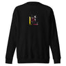 Front view of a solid-colored sweatshirt. A small graphic on the chest features a high-contrast, crystalline shape with lines radiating from it to create a shattered glass effect. The design is layered over a patterned rectangular block.